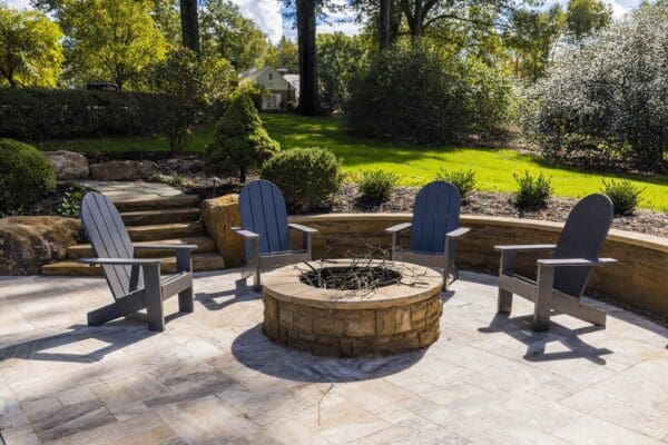 Outdoor Patio with Fire Pit photo of backyard hardscape installation of circular patio with natural stone and fire pit